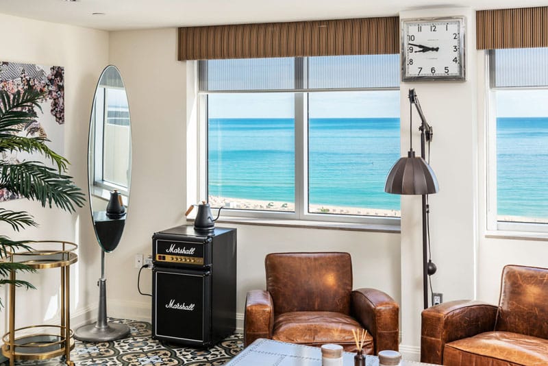 A wide view of a hotel room with a beach view.