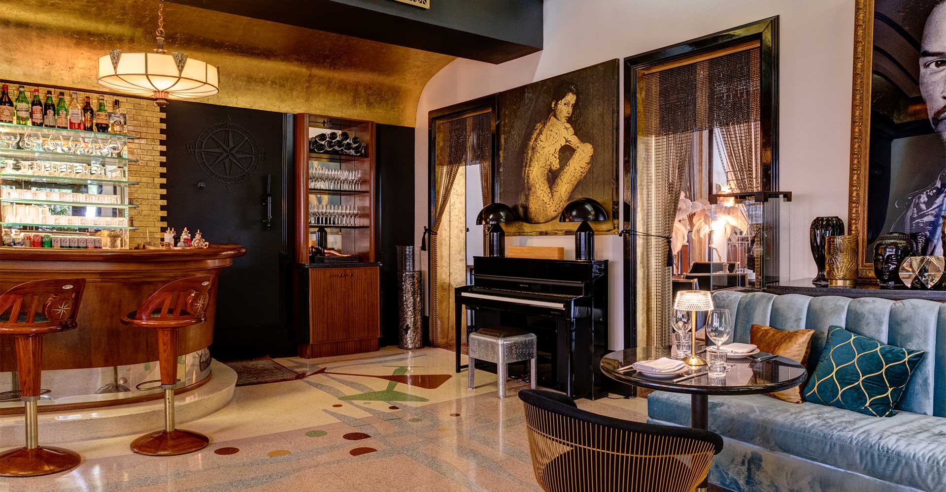 A stylish lounge with a bar, piano, and comfortable seating.
